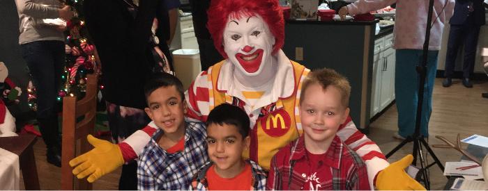 Ronald McDonald and a 3 children in the kitchen of the Columbus Ronald McDonald House. Community Fundraiser.