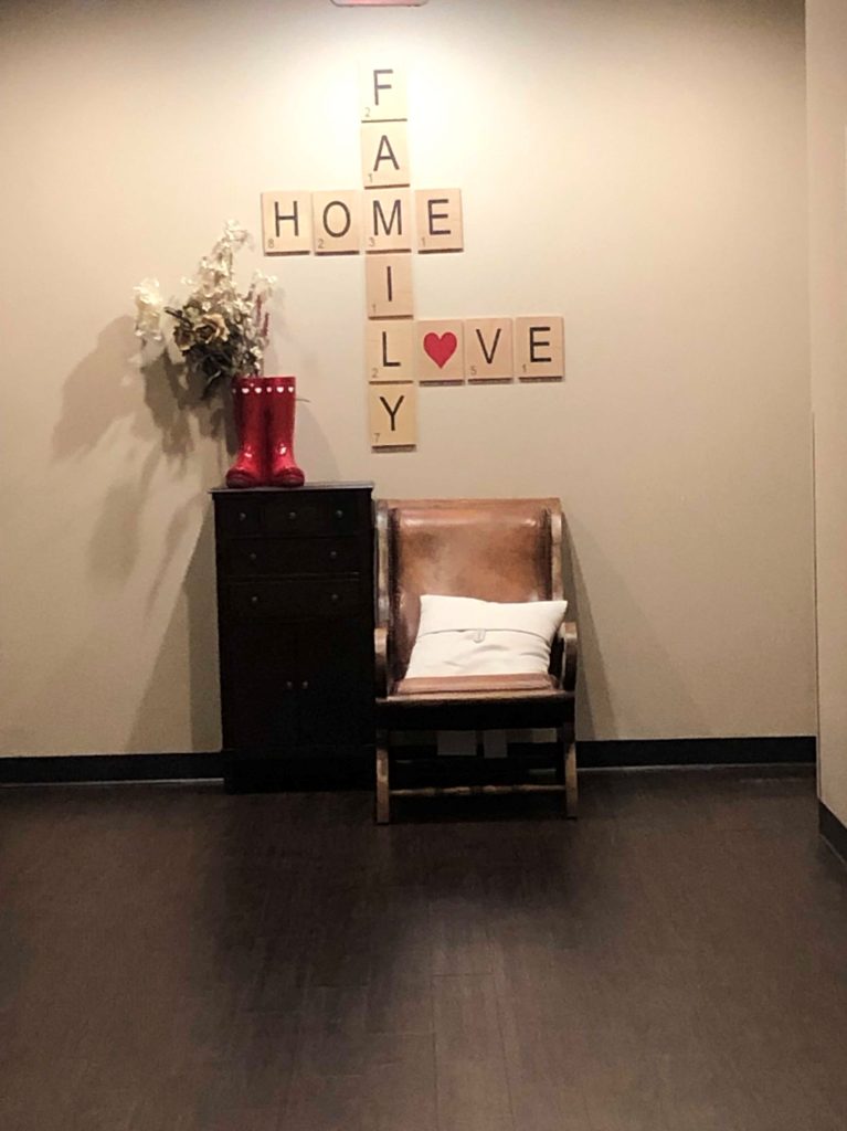 Wall decor shows the words family, home & love.