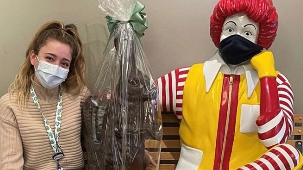 Jenna, a large chocolate bunny in cellophane, and statue of Ronald McDonald sitting on a bench.