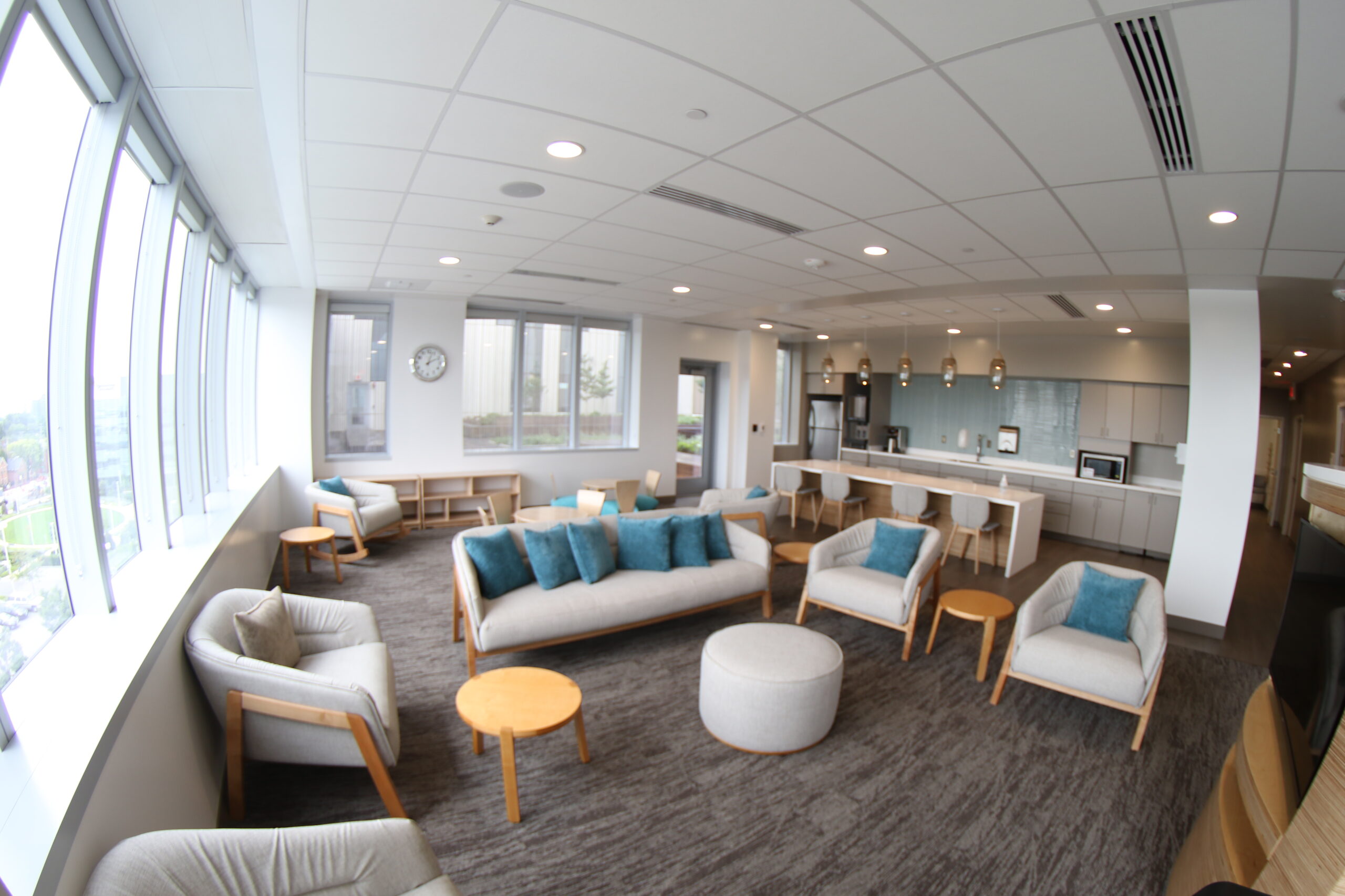 A view of the Ronald McDonald Family Room showing a couch and chairs with the kitchenette in the background.