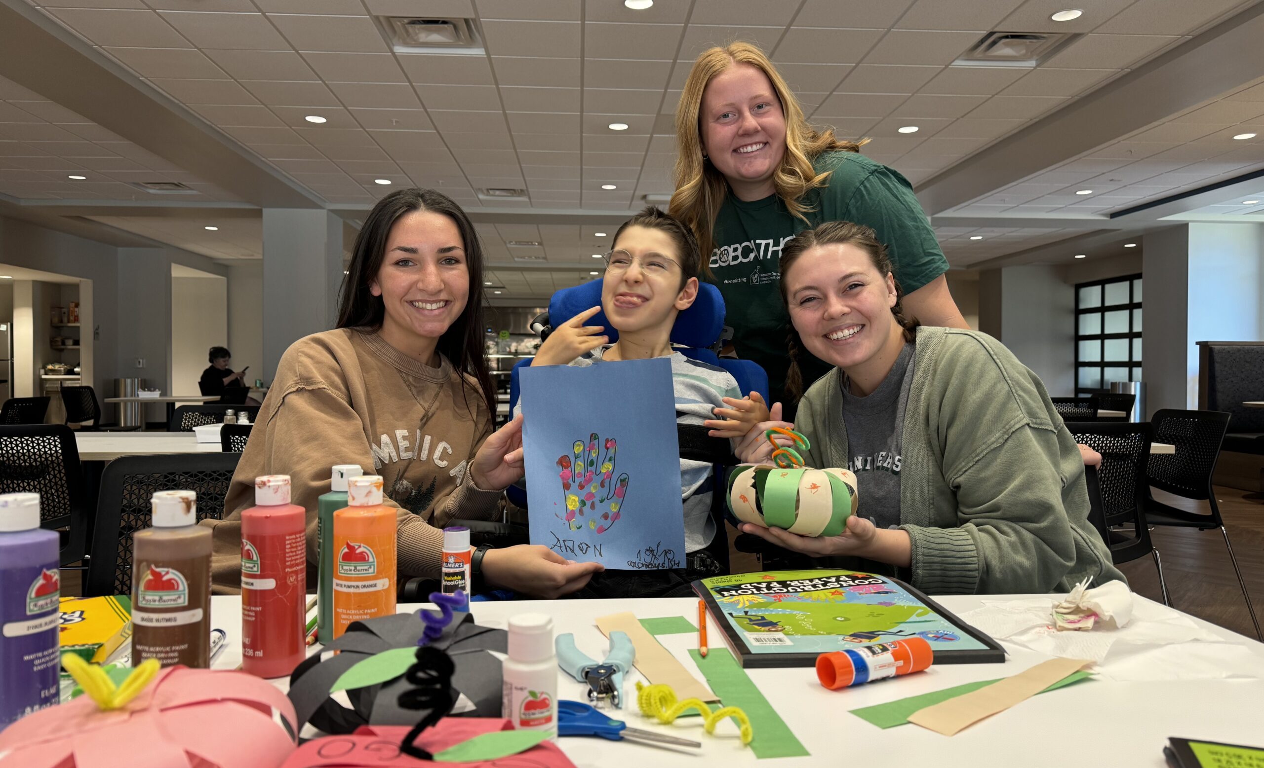 Group doing craft activities with child