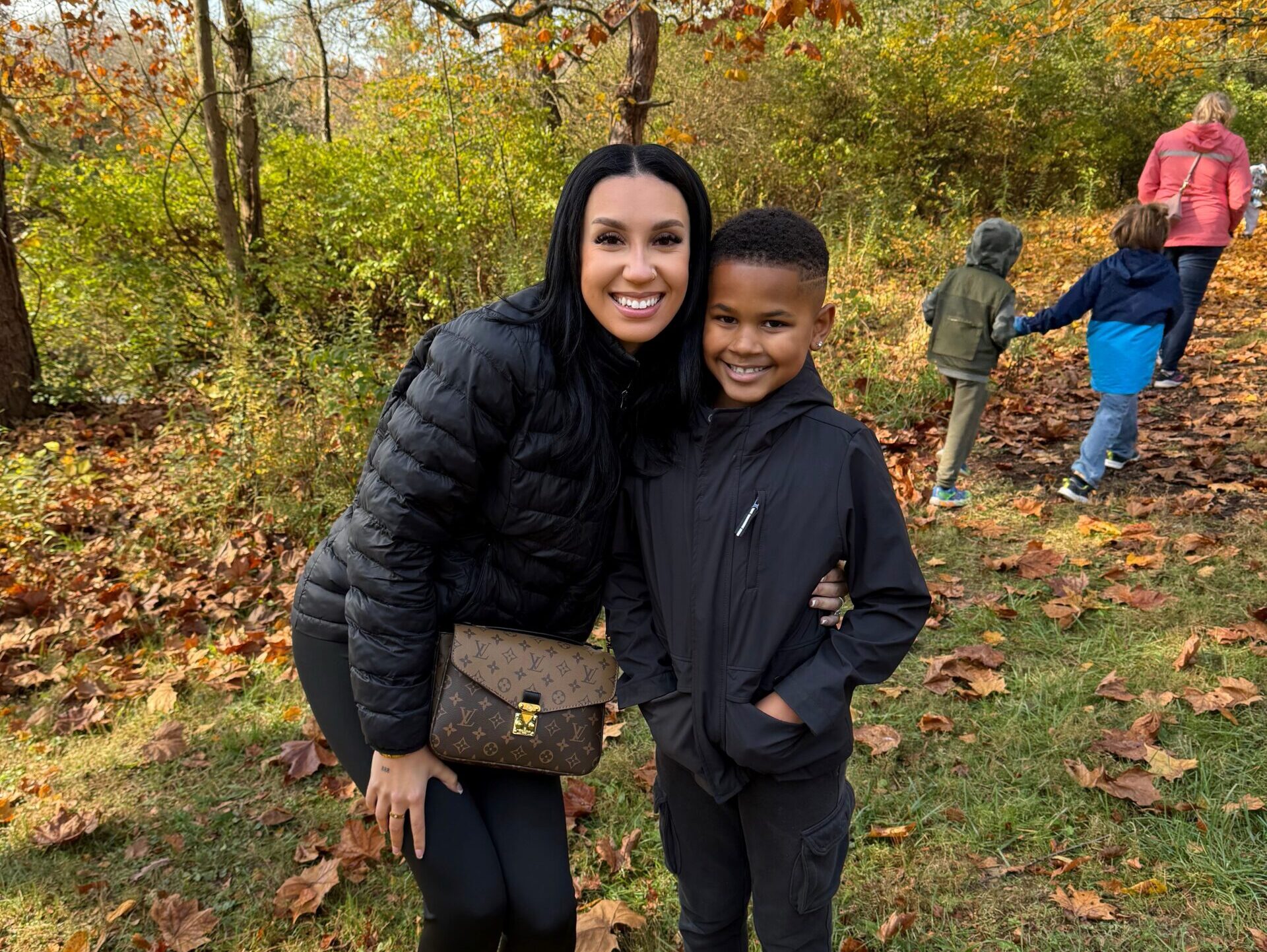 Mother and son surrounded by fall foliage