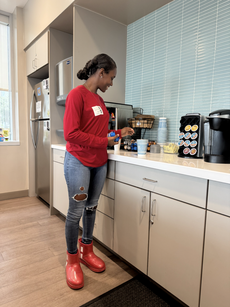 Kaylah’s friend and Dom’s godmother making a coffee in the room